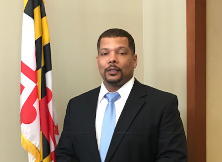 Man in front of maryland flag