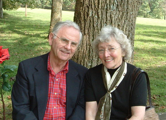 Photo of the Garlands sitting by a tree.