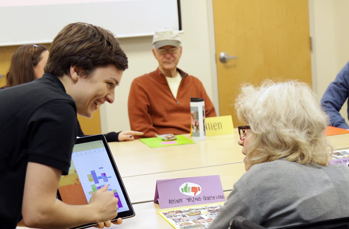 Loyola Clinical Center assistant helping a patient use a tablet computer