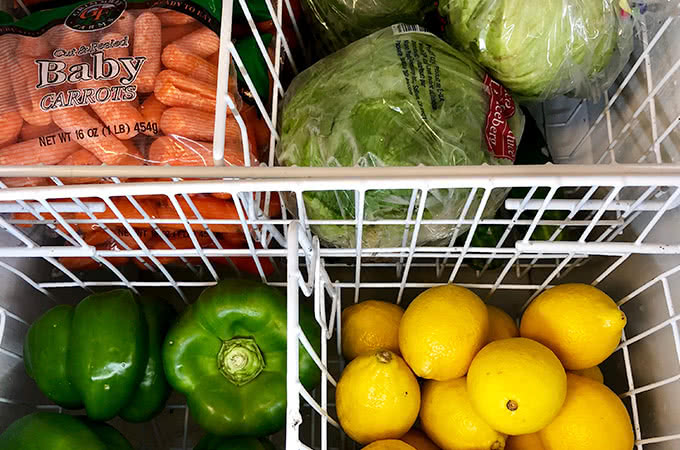 Refrigerated produce, including carrots, lettuce, peppers, and lemons