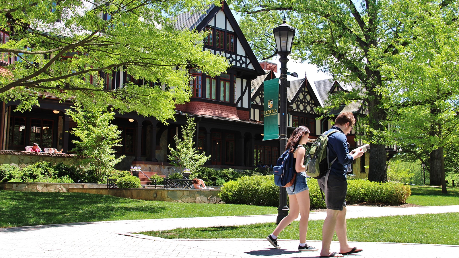 Two students walking in front of the Humanities Center on Loyola's Evergreen campus