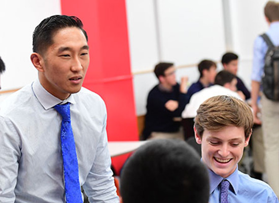 Andrew Kent sitting with fellow alumni.