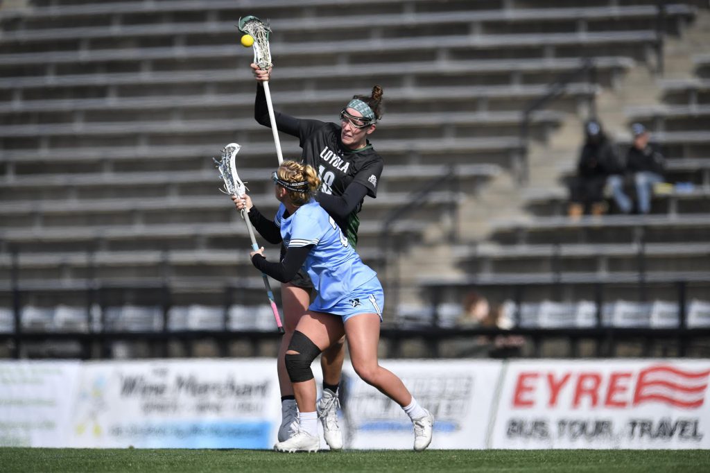 Taylor VanThof tries to hold the ball as she runs.