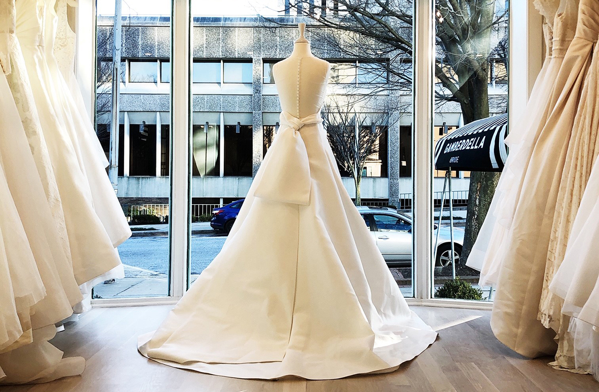 White wedding dress in facing out onto the street from the shopping window.