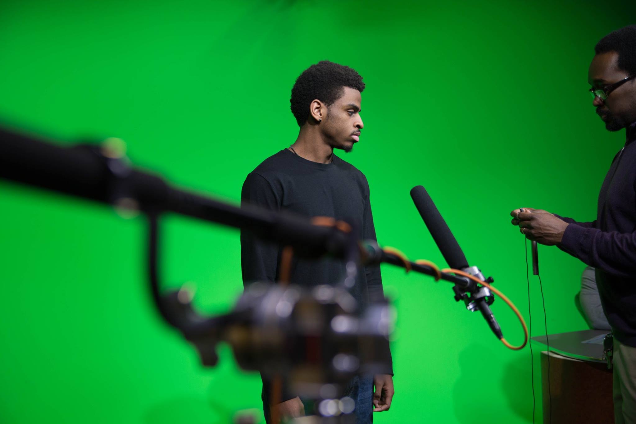 Student with a long mic extended towards him.