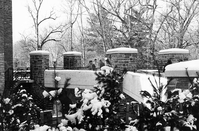 The pedestrian bridge that crosses Charles St. covered in snow