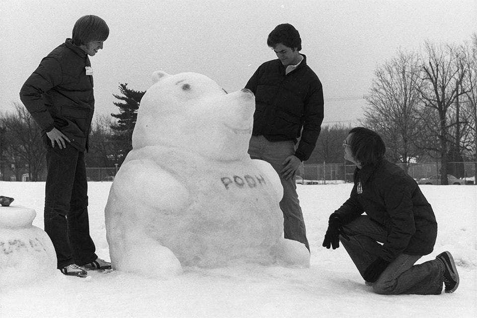 Group of Loyola students making a Winnie-the-Pooh snow sculpture