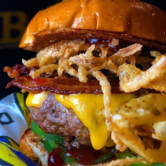 Close-up shot of a bacon cheeseburger