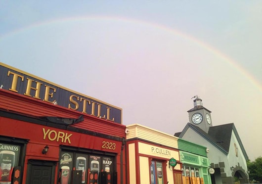 Exterior of The Still pub with a rainbow in the background