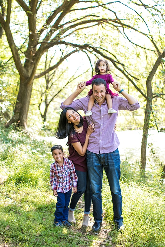 Portrait photo of young family posing outdoors