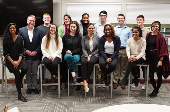 Student and faculty members of the Social Impact Fellowship program pose for a photo