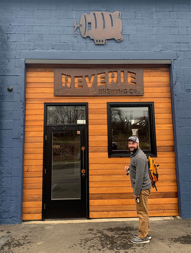 Ryan Broderick standing in front of the entrance of Reverie Brewing Co