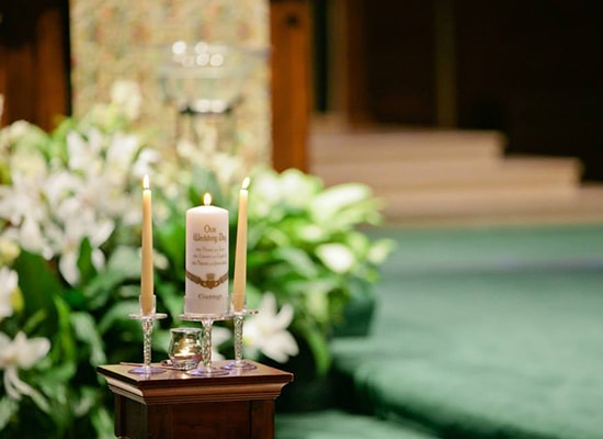 Wedding themed candles in the Loyola Alumni Memorial Chapel