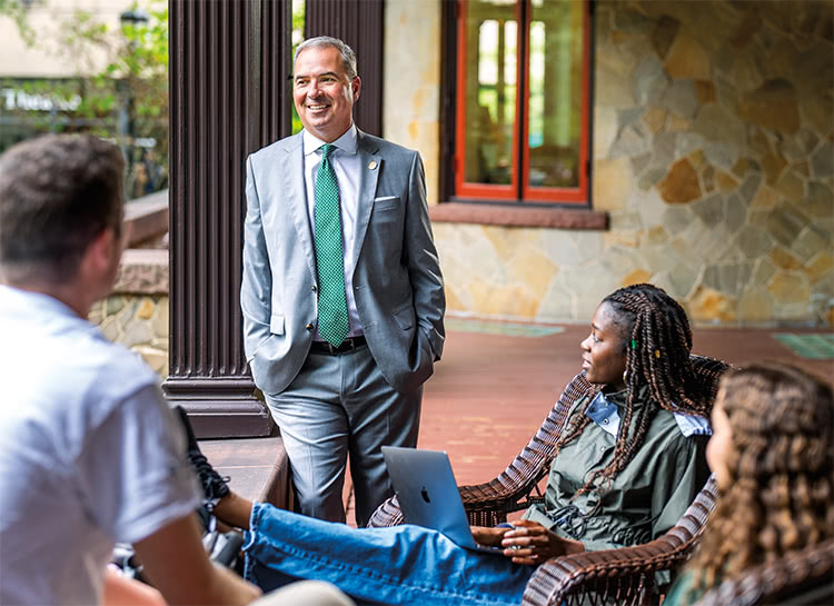 Terry Sawyer talking to a group of students on the porch of the Humanities Building