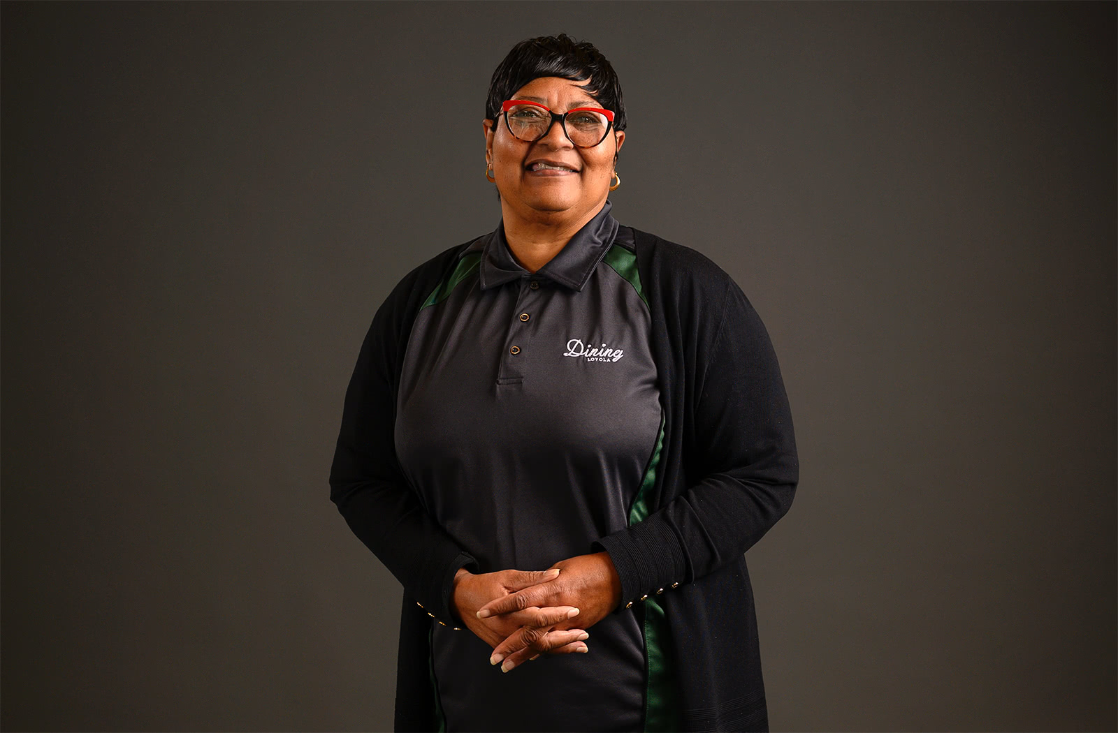 Diane Parker poses for a photo while wearing her Loyola Dining uniform