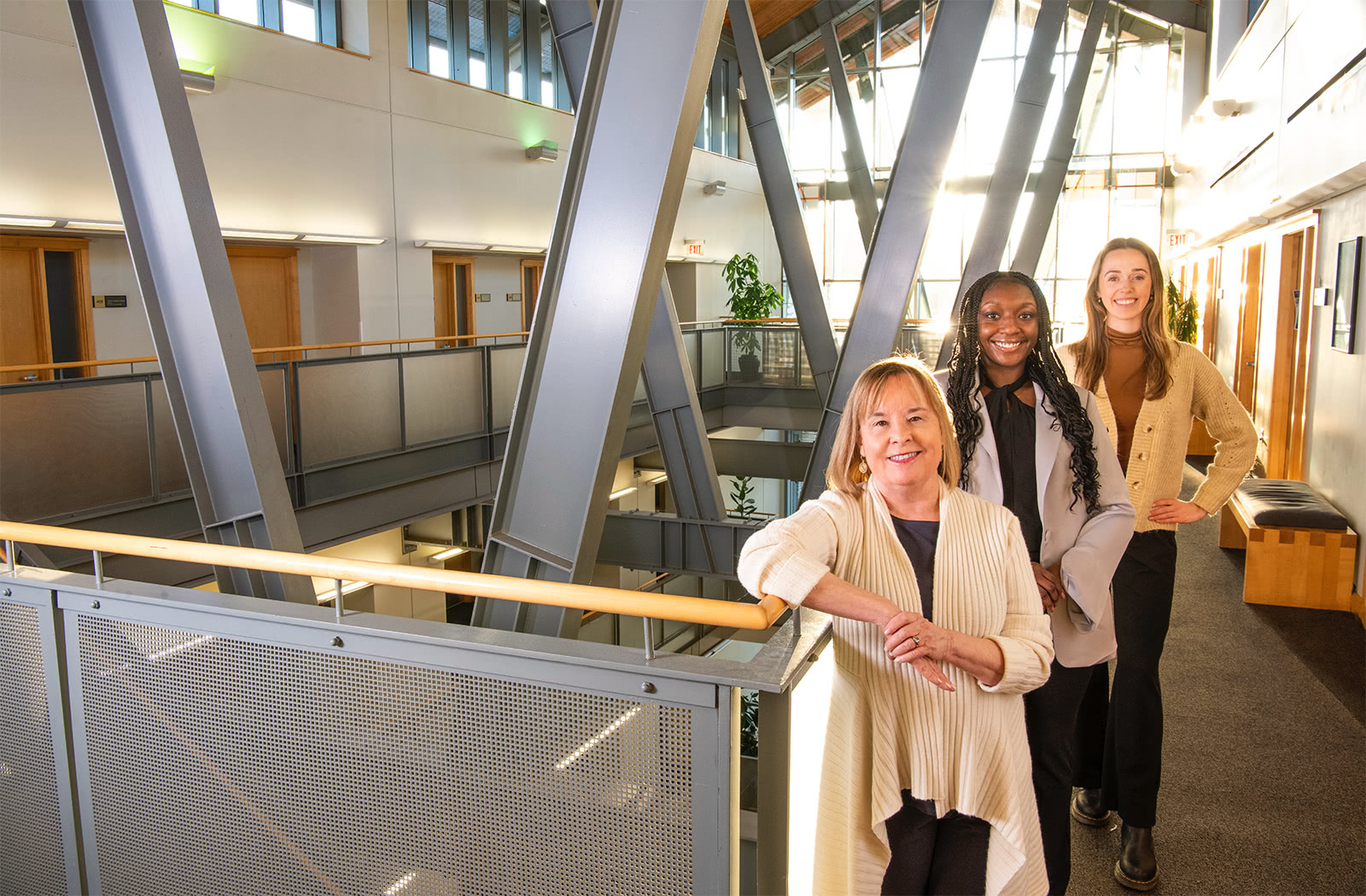 Andrea Giampetro-Meyer, Janae James, and Sydney Brooke pose for a photo in the Sellinger building