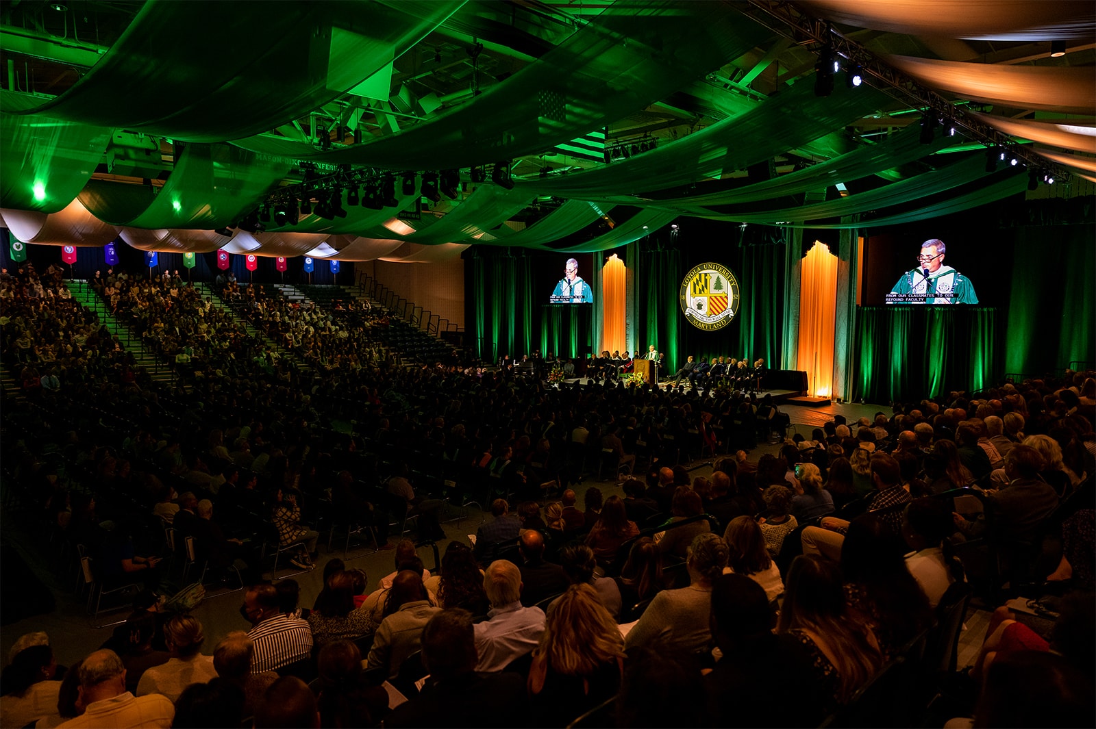 A large group gathered at Reitz Arena listens to President Terry Sawyer's inauguration speech