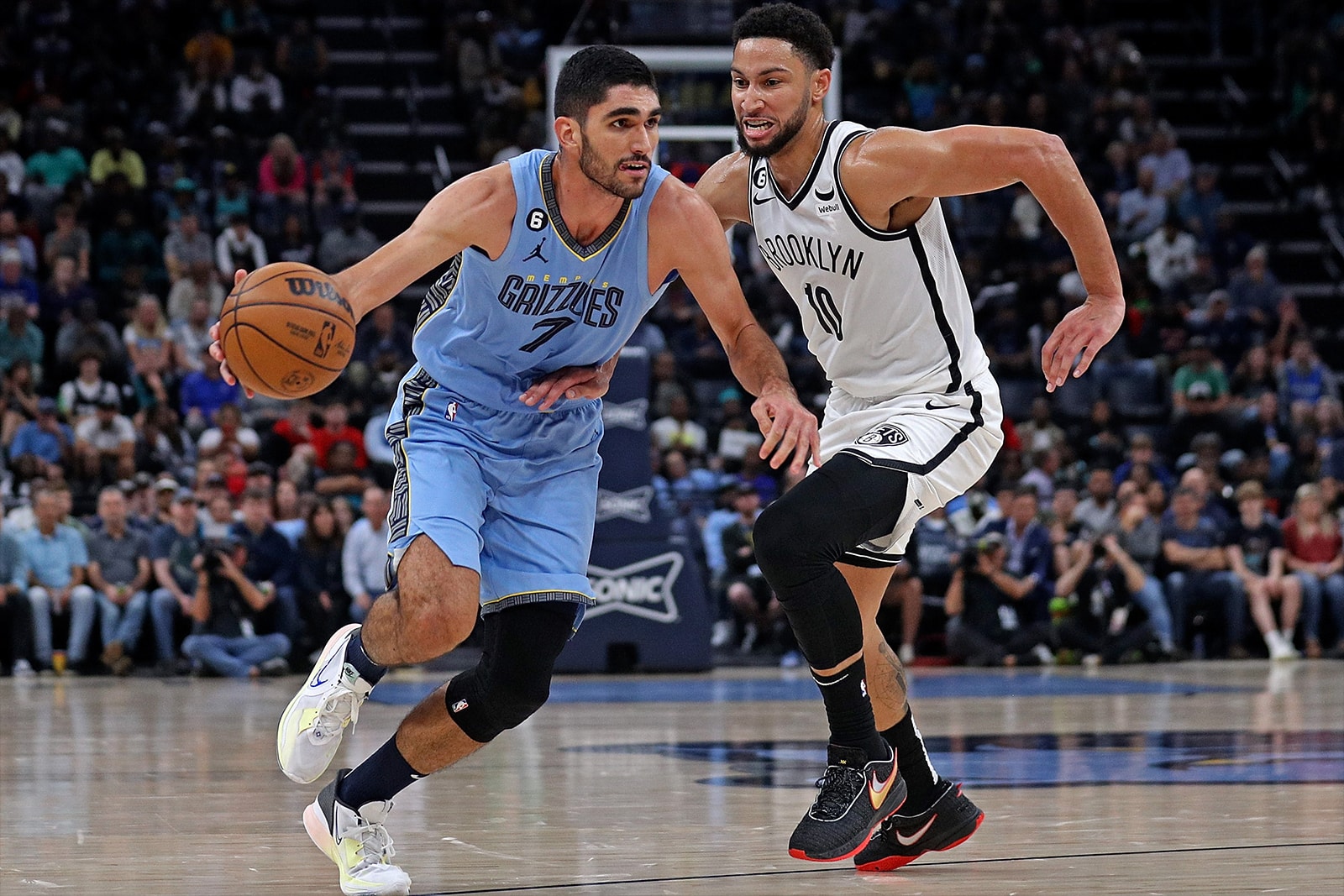 Santi Aldama dribbles into the zone past Ben Simmons while playing in an NBA game