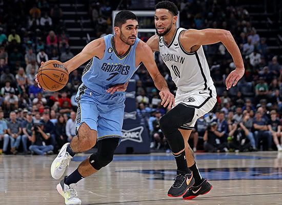 Santi Aldama dribbles into the zone past Ben Simmons while playing in an NBA game