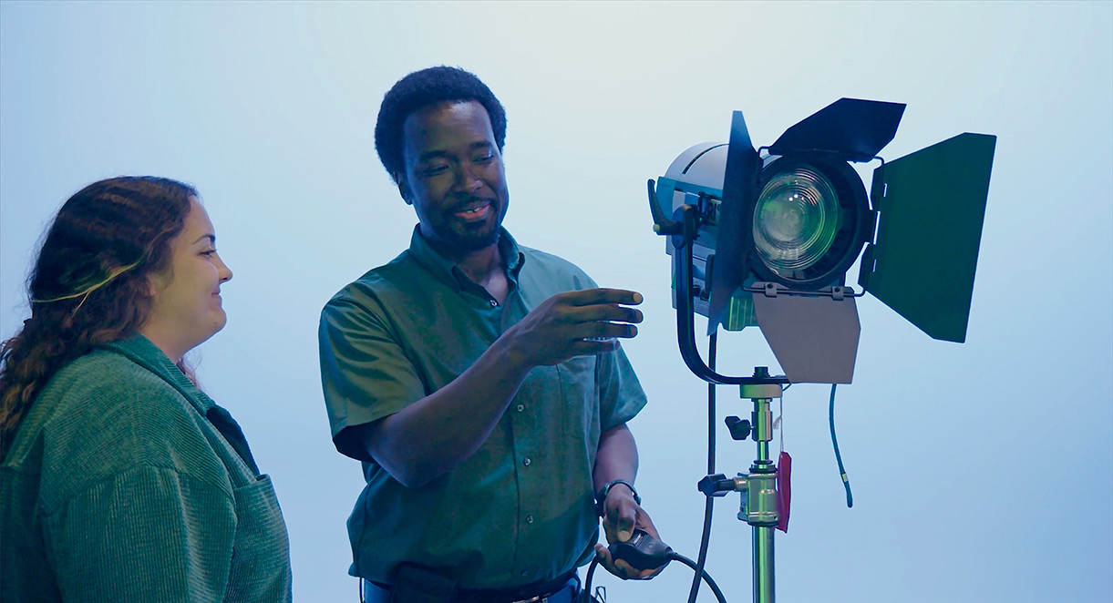 Jay Dunmore and April Hartman working with a studio light