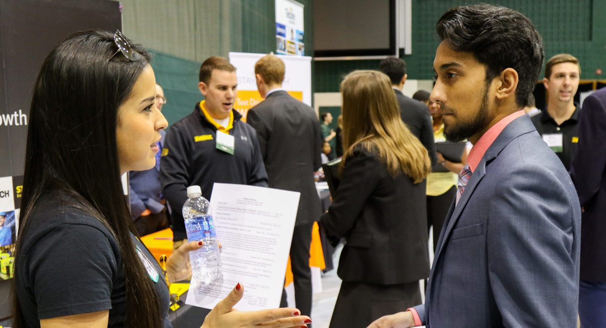 A student talks with a recruiter during a career fair