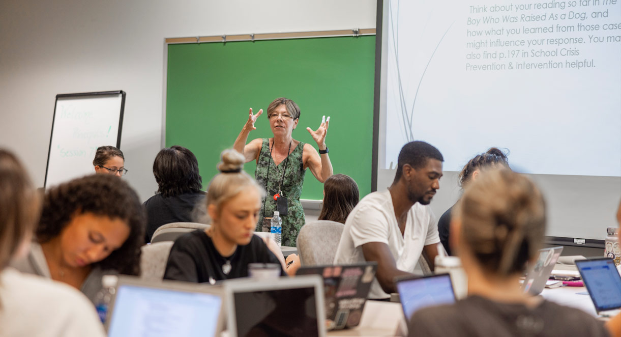 A professor teaching in a classroom