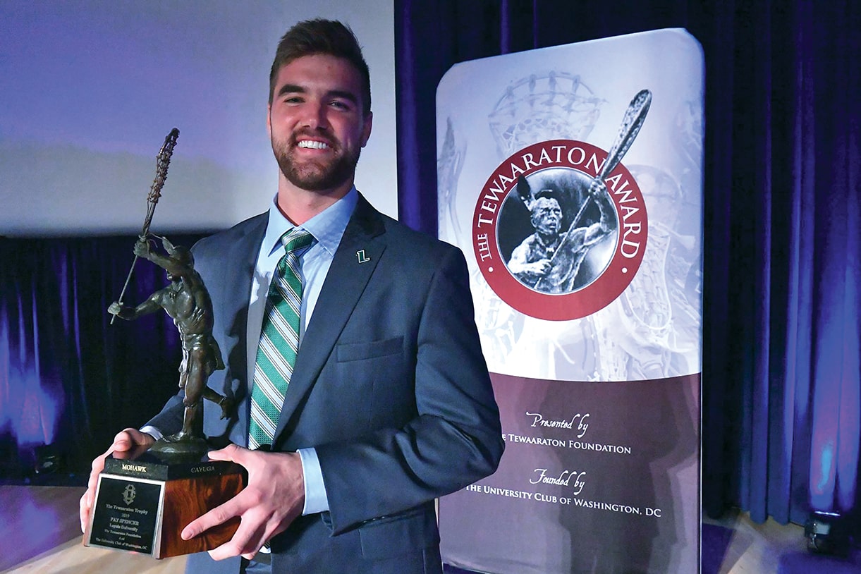 Pat Spencer, ’19 holding the 2019 Tewaaraton Award