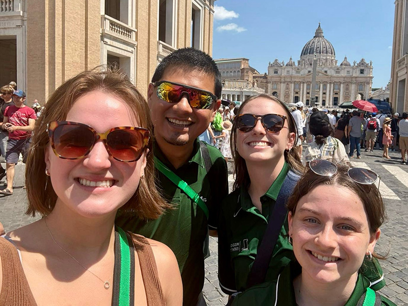 Loyola Students take a selfie with the Vatican in the background