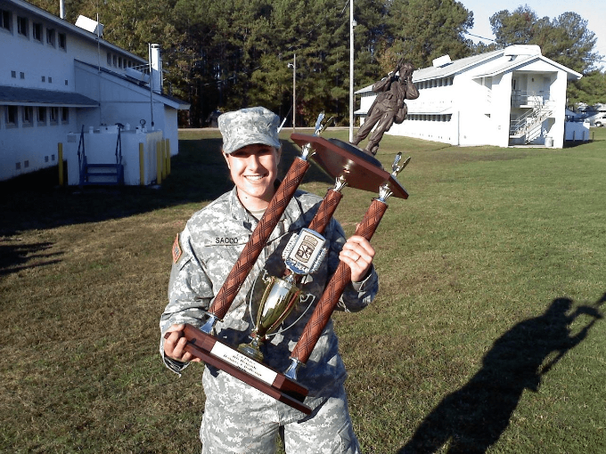 Christel Hiltibran in uniform carrying a trophy