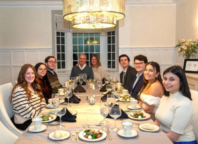 President Terry Sawyer and Courtney Sawyer host a group of seniors for dinner at the Armiger House