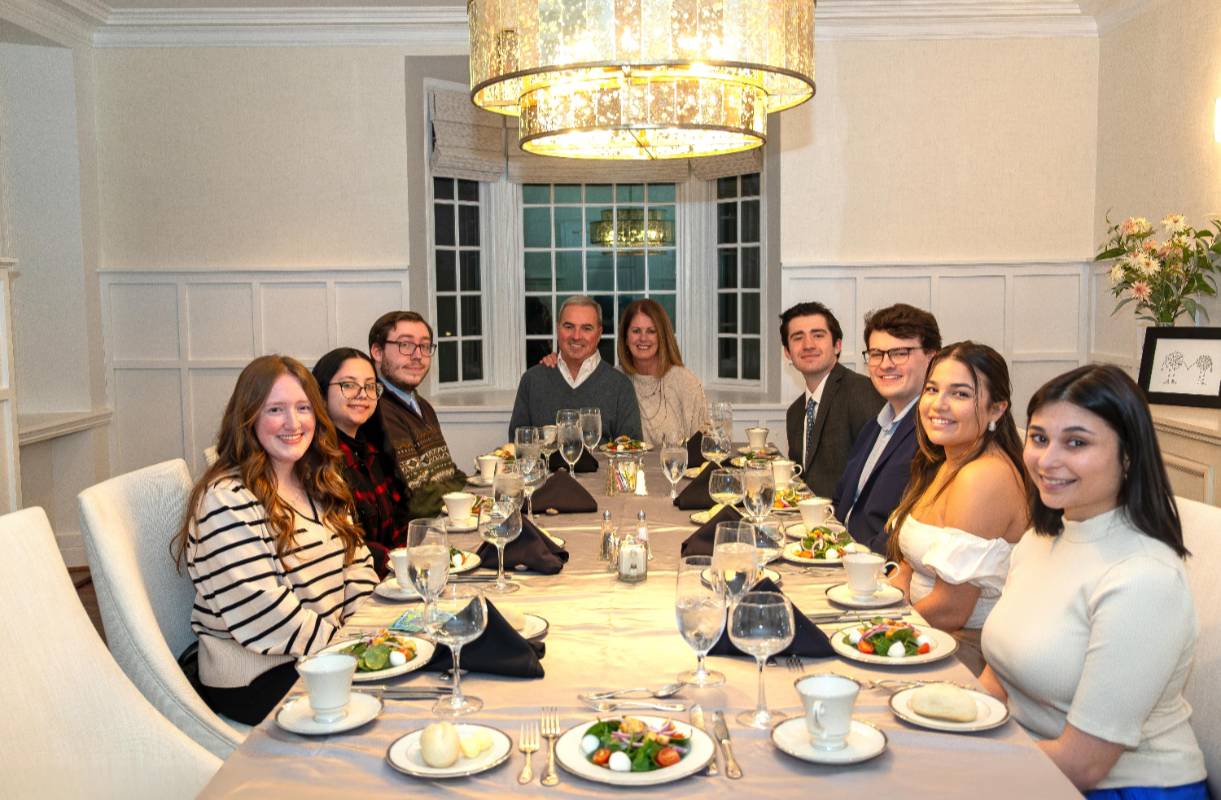 President Terry Sawyer and Courtney Sawyer host a group of seniors for dinner at the Armiger House