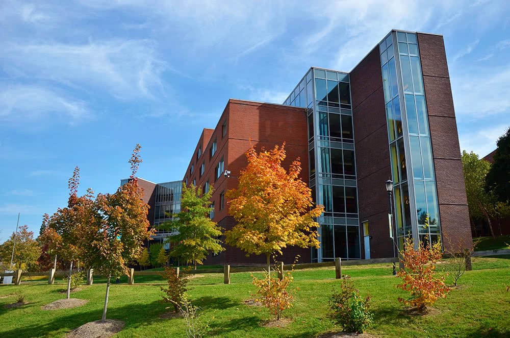 Thea Bowman Hall with trees changing color in the fall