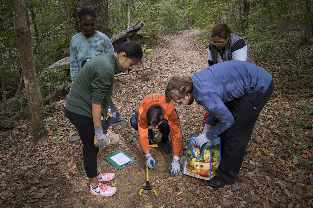 Students picking up trash during a clean up day at the Stony Run Stream in Baltimore