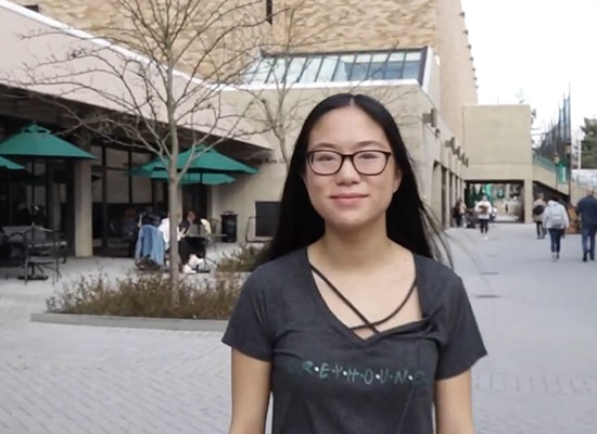 Female student leading a tour of campus