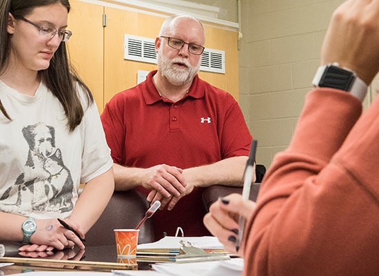 Student and forensics professor reviewing an experiment