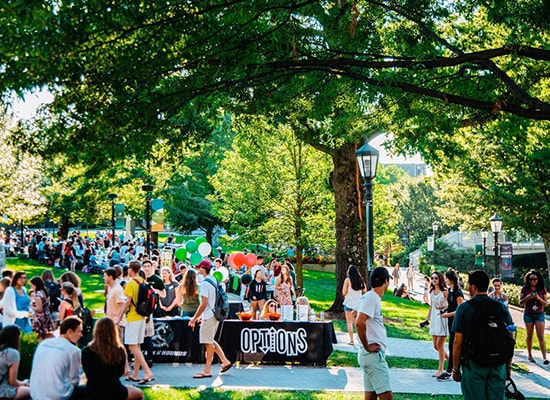 Students filling academic Quad as they browse informational tables at the student activities fair