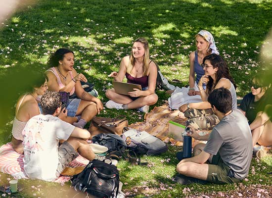 Students gather on the Loyola academic quad in spring