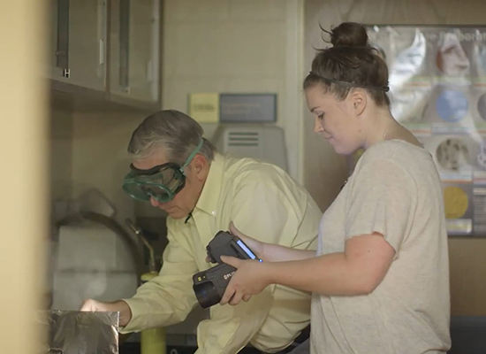 Student and physics professor working on a research project