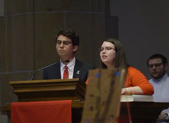 Students standing at podium in the Alumni Memorial Chapel