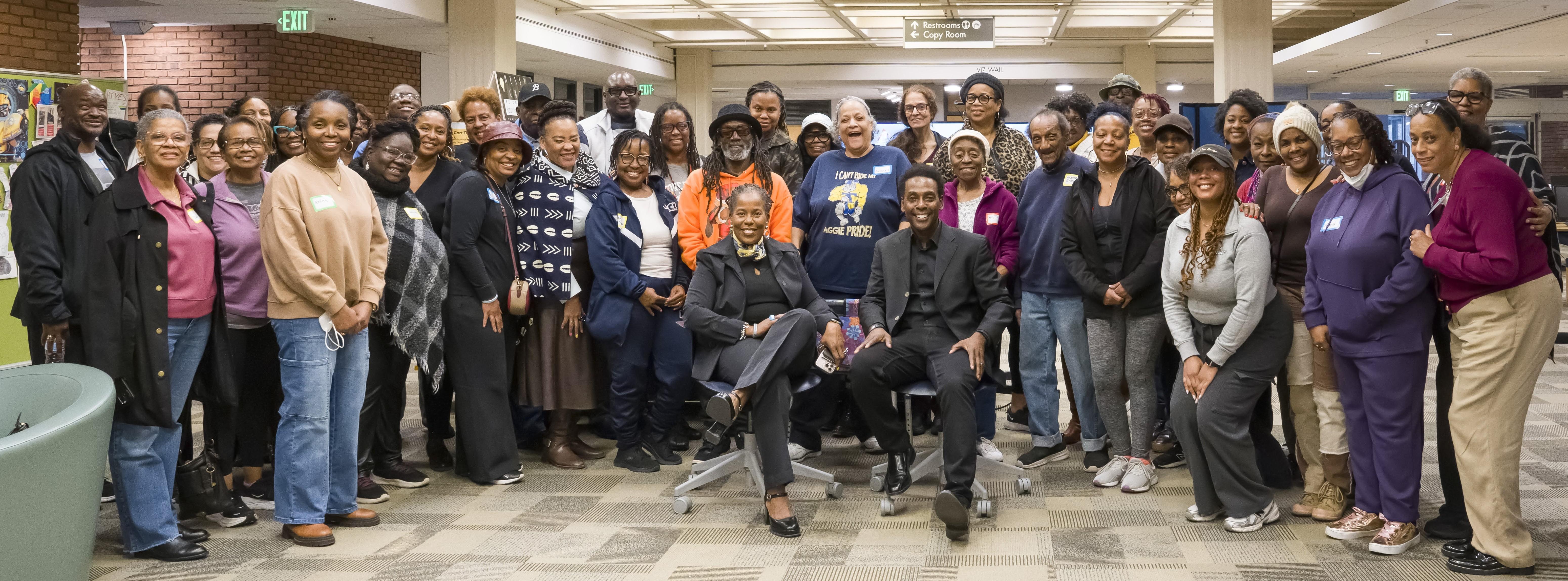 Dr Kaye and Dr Darnell Lamar Shields with students of the Touch of Freedom School in the Loyola Notre Dame Library