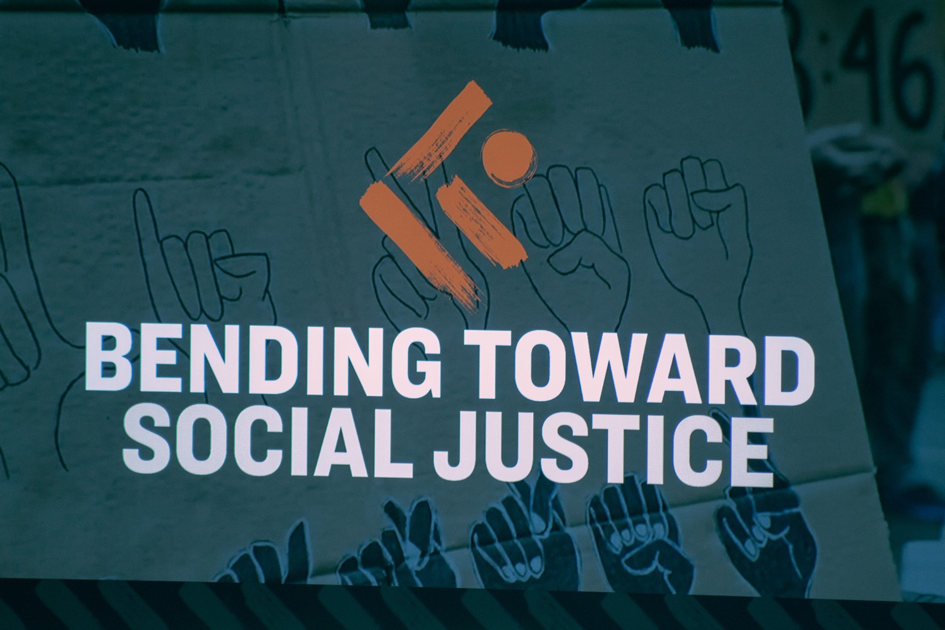 Karson Institute Logo signage with Bending toward social justice written on it