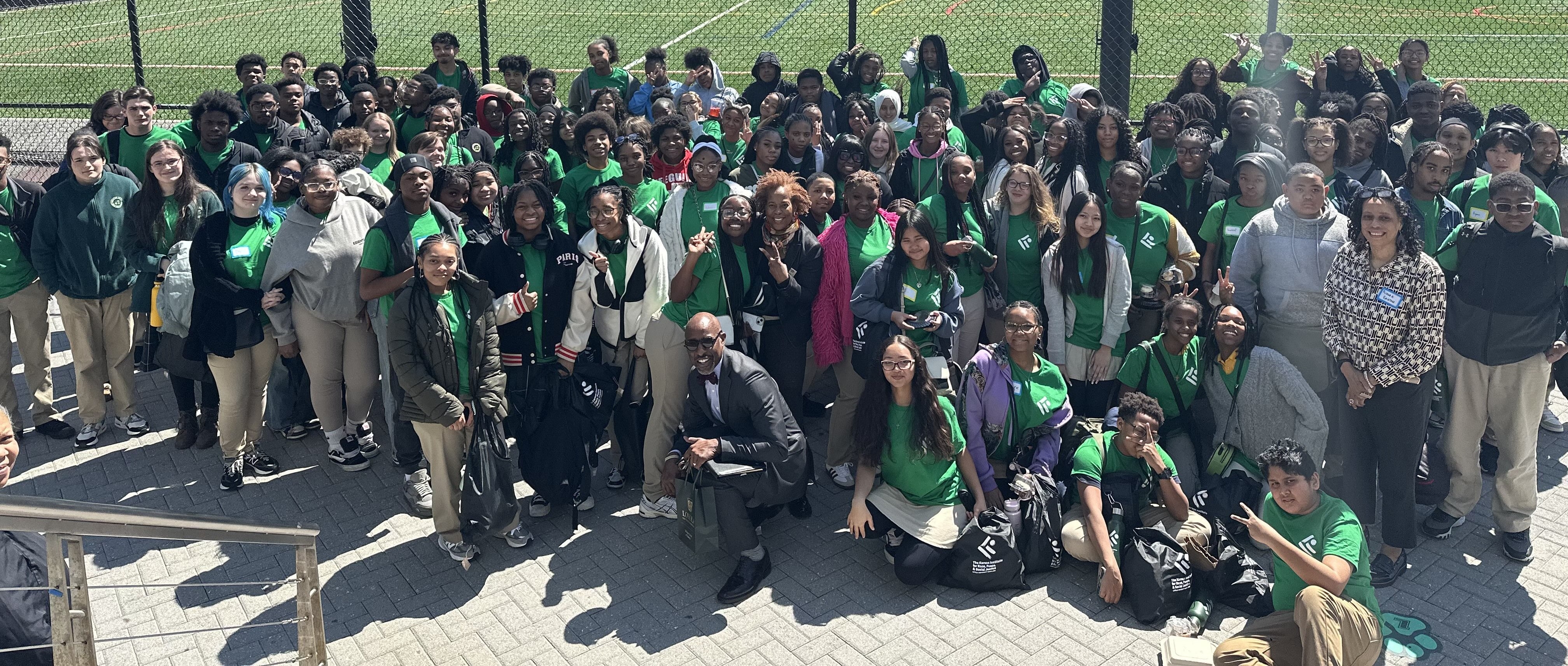 Doctor Kaye with a group of students outside of the Andrew White Student Center