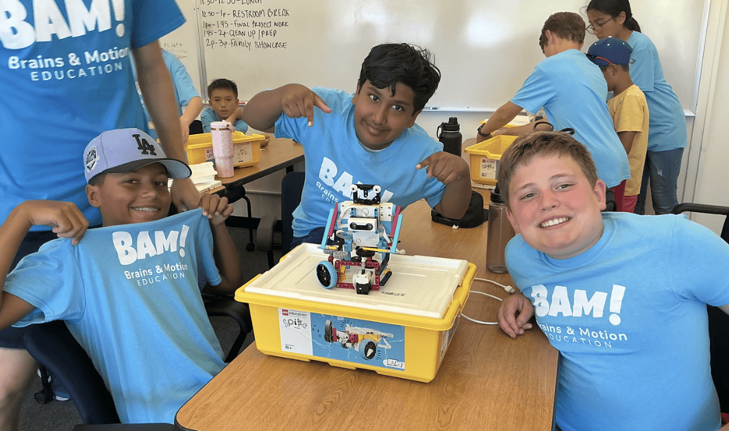 A group of three students surrounding a project