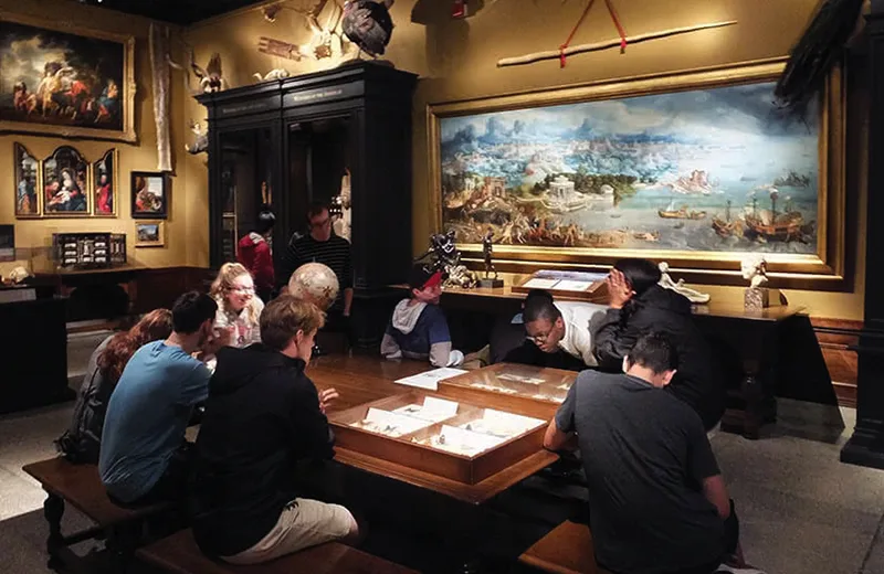 Students looking at objects in a museum