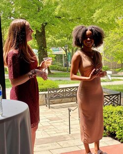 Knekiya Harper gave a speech on the porch of the Humanities during the CPC graduation celebration. CPC Program Director Dr. Emalee Quickel cheers her on.