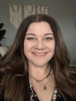 headshot of a lady with long hair, smiling