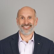 Guy smiling and wearing a black suit