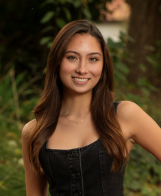 a lady with a long hair wearing black sleeveless top