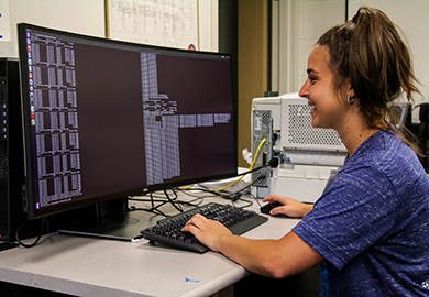 Female computer science student working at computer