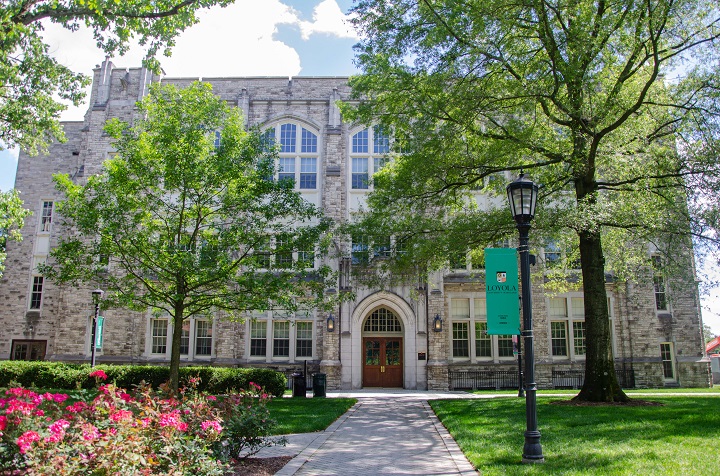 Jenkins Hall framed by trees and blooming flowers